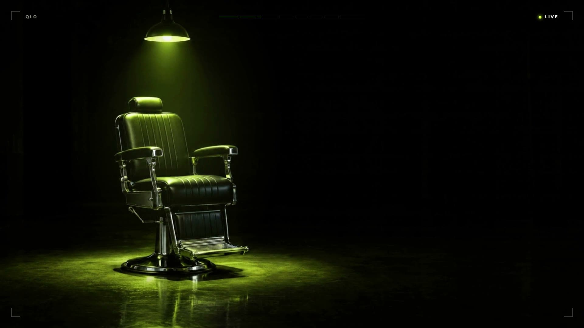 An empty barber’s chair under a single lamp, lit lime.